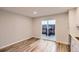Living room with modern flooring and sliding glass door to backyard patio at 1811 S Quebec Way # 31, Denver, CO 80231