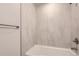 Modern shower features marbled tile from floor to ceiling and updated shower head fixture at 1811 S Quebec Way # 31, Denver, CO 80231