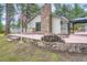 Spacious backyard with a stone chimney, outdoor grill, fire pit and lounging area at 26732 Main St, Conifer, CO 80433