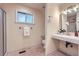 Bathroom featuring vanity, shower and tile flooring and a window for light at 26732 Main St, Conifer, CO 80433