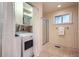 Bathroom and laundry room featuring a shower, storage closet and a washer/dryer unit at 26732 Main St, Conifer, CO 80433