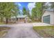 Charming home exterior with a spacious driveway, garage, and mature trees at 26732 Main St, Conifer, CO 80433