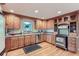 Charming kitchen with wood cabinets, stainless appliances, granite counters, and hardwood floors at 26732 Main St, Conifer, CO 80433
