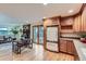 Kitchen open to living room, featuring stainless appliances, wood cabinets, and hardwood floors at 26732 Main St, Conifer, CO 80433