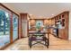 Kitchen featuring custom wood cabinets, hardwood floors, stainless steel appliances, and a dining table at 26732 Main St, Conifer, CO 80433