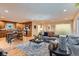 Spacious open-concept living room and kitchen area with hardwood floors and modern furniture at 26732 Main St, Conifer, CO 80433