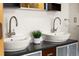 Elegant bathroom featuring double sinks with modern faucets at 1942 Kentmere Dr, Longmont, CO 80504
