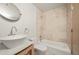 Well-lit bathroom with a vessel sink, tiled shower and tub, and modern fixtures at 1942 Kentmere Dr, Longmont, CO 80504