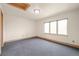 Cozy bedroom featuring a large window for natural light and neutral carpeting at 1942 Kentmere Dr, Longmont, CO 80504