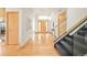 Spacious foyer with hardwood floors, modern staircase, and decorative art at 1942 Kentmere Dr, Longmont, CO 80504
