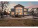 Beautiful two-story home featuring a stone facade, large windows, landscaping, and a well-manicured front lawn at 1942 Kentmere Dr, Longmont, CO 80504