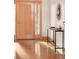Warm foyer with wood floors and modern console table beneath decorative wall art at 1942 Kentmere Dr, Longmont, CO 80504
