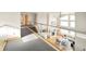 Open-concept floor plan with living room view from upstairs hallway with glass railings at 1942 Kentmere Dr, Longmont, CO 80504