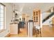 Open kitchen design features granite countertops, island with seating, and hardwood floors at 1942 Kentmere Dr, Longmont, CO 80504