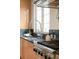 Close-up of kitchen features stainless steel stove, granite counters, and modern faucet at 1942 Kentmere Dr, Longmont, CO 80504