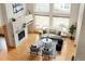 Bright living room with hardwood floors, stone fireplace, and large windows offering plenty of natural light at 1942 Kentmere Dr, Longmont, CO 80504