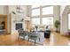 Bright living room with high ceilings, hardwood floors, modern furnishings, and large windows at 1942 Kentmere Dr, Longmont, CO 80504