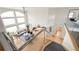 Bright, open living room features a soaring ceiling, large windows, and stylish contemporary furnishings at 1942 Kentmere Dr, Longmont, CO 80504