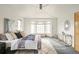 Cozy primary bedroom with plush rug, ceiling fan, and bay window seating area at 1942 Kentmere Dr, Longmont, CO 80504
