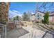Backyard patio with built-in stone grill, stainless steel doors, and metal fence against a cozy home exterior at 1942 Kentmere Dr, Longmont, CO 80504