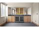 Basement wet bar features built-in cabinets, countertop space, sink, and wine fridge at 1942 Kentmere Dr, Longmont, CO 80504