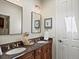 Bathroom with double sinks and dark wood cabinets at 6405 Warriors Run, Littleton, CO 80125
