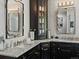 Beautiful bathroom with double vanities, a marble countertop, and elegant fixtures at 6405 Warriors Run, Littleton, CO 80125
