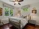 Cozy bedroom with hardwood floors, comfortable bed and bright natural light at 6405 Warriors Run, Littleton, CO 80125
