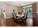 Formal dining room with chandelier, wallpaper, hardwood flooring, and access to the backyard at 6405 Warriors Run, Littleton, CO 80125