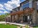Stone and siding accentuates the exterior of the home with multiple outdoor living spaces at 6405 Warriors Run, Littleton, CO 80125