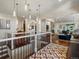 Beautiful foyer with hardwood floors and modern light fixtures leading to the living room at 6405 Warriors Run, Littleton, CO 80125