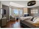 Spacious main bedroom offers a cozy fireplace, hardwood floors, and large windows with scenic views at 6405 Warriors Run, Littleton, CO 80125