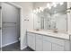Bathroom featuring a double sink vanity with quartz countertop and walk-in shower at 451 Interlocken Blvd # 104, Broomfield, CO 80021