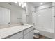Bathroom featuring single sink vanity, quartz countertop and a bathtub/shower combo at 451 Interlocken Blvd # 104, Broomfield, CO 80021