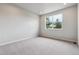 Comfortable bedroom with neutral walls, carpet, and window views of trees, offering peaceful retreat at 451 Interlocken Blvd # 104, Broomfield, CO 80021