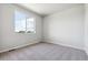 Bright bedroom with neutral carpet, large window providing natural light and neighborhood view at 451 Interlocken Blvd # 104, Broomfield, CO 80021