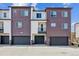 Exterior view of modern townhomes featuring attached garages and private balconies at 451 Interlocken Blvd # 104, Broomfield, CO 80021