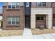 View of front entrance with brick and stone exterior and professional landscaping at 451 Interlocken Blvd # 104, Broomfield, CO 80021