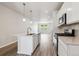 Bright kitchen showcases center island, stainless appliances, modern lighting, and sleek countertops at 451 Interlocken Blvd # 104, Broomfield, CO 80021