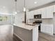 Contemporary kitchen offers center island with sink, light countertops, stainless appliances, and wood-look floors at 451 Interlocken Blvd # 104, Broomfield, CO 80021