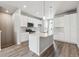 Stylish kitchen presents expansive island, modern appliances, and bright white cabinets, perfect for cooking at 451 Interlocken Blvd # 104, Broomfield, CO 80021