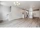 Open-concept living room featuring wood floors, modern lighting, stairs to the upper level, and view of kitchen area at 451 Interlocken Blvd # 104, Broomfield, CO 80021