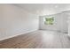Spacious living room featuring wood floors, neutral paint, and natural light with a view to the outside at 451 Interlocken Blvd # 104, Broomfield, CO 80021