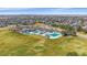 Aerial image showcasing the community's large swimming pool and proximity to neighborhood homes at 10240 Travertine Pl, Parker, CO 80134
