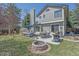 Spacious backyard featuring an outdoor seating area, built-in grill, dining area, and relaxing fire pit at 10240 Travertine Pl, Parker, CO 80134