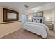 Bright bedroom featuring carpeted floors, a plush queen-sized bed, and plentiful natural light from the window at 10240 Travertine Pl, Parker, CO 80134