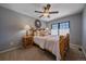 Cozy bedroom with ceiling fan, a decorative mirror, and custom wood trim at 10240 Travertine Pl, Parker, CO 80134