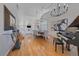 Bright dining room with hardwood floors, elegant chandeliers, grand piano and large windows at 10240 Travertine Pl, Parker, CO 80134