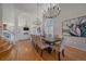 Dining area features hardwood floors, large windows, decorative chandelier and living room in the background at 10240 Travertine Pl, Parker, CO 80134