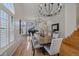 Dining area features hardwood floors, large windows, decorative chandelier and grand piano at 10240 Travertine Pl, Parker, CO 80134